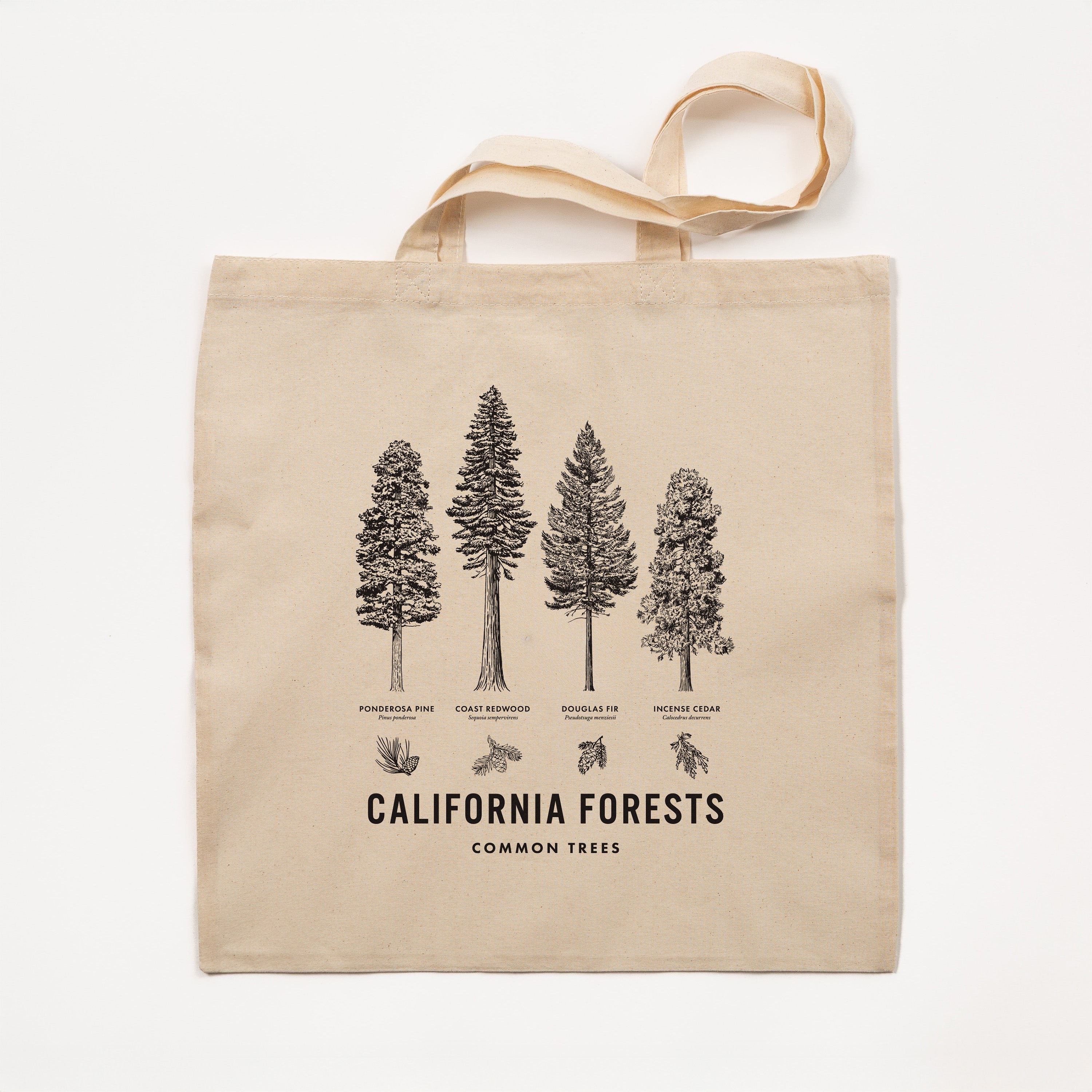 Beige tote bag with black tree illustrations and text on a white background