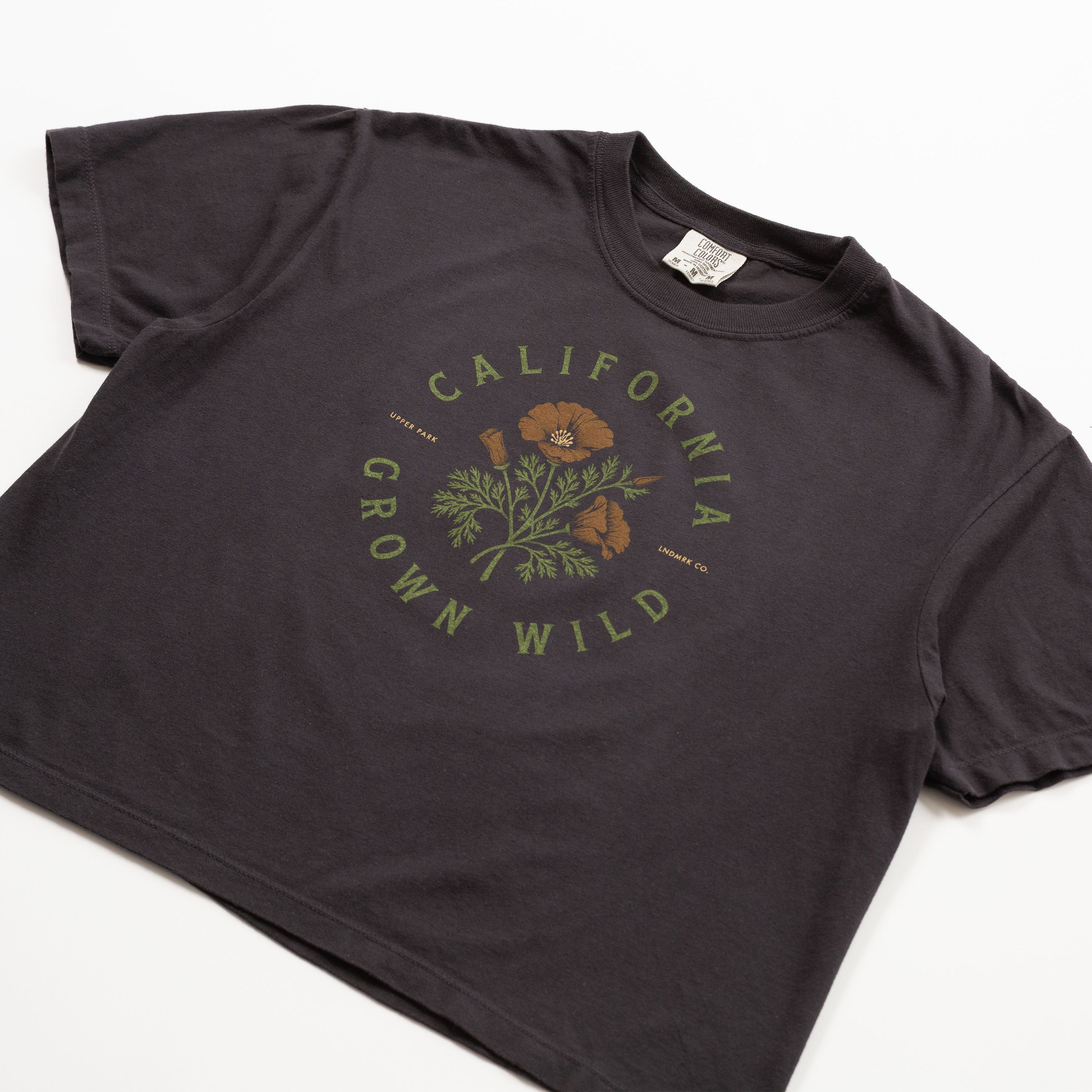 Black t-shirt with 'California Grown Wild' graphic on a white background