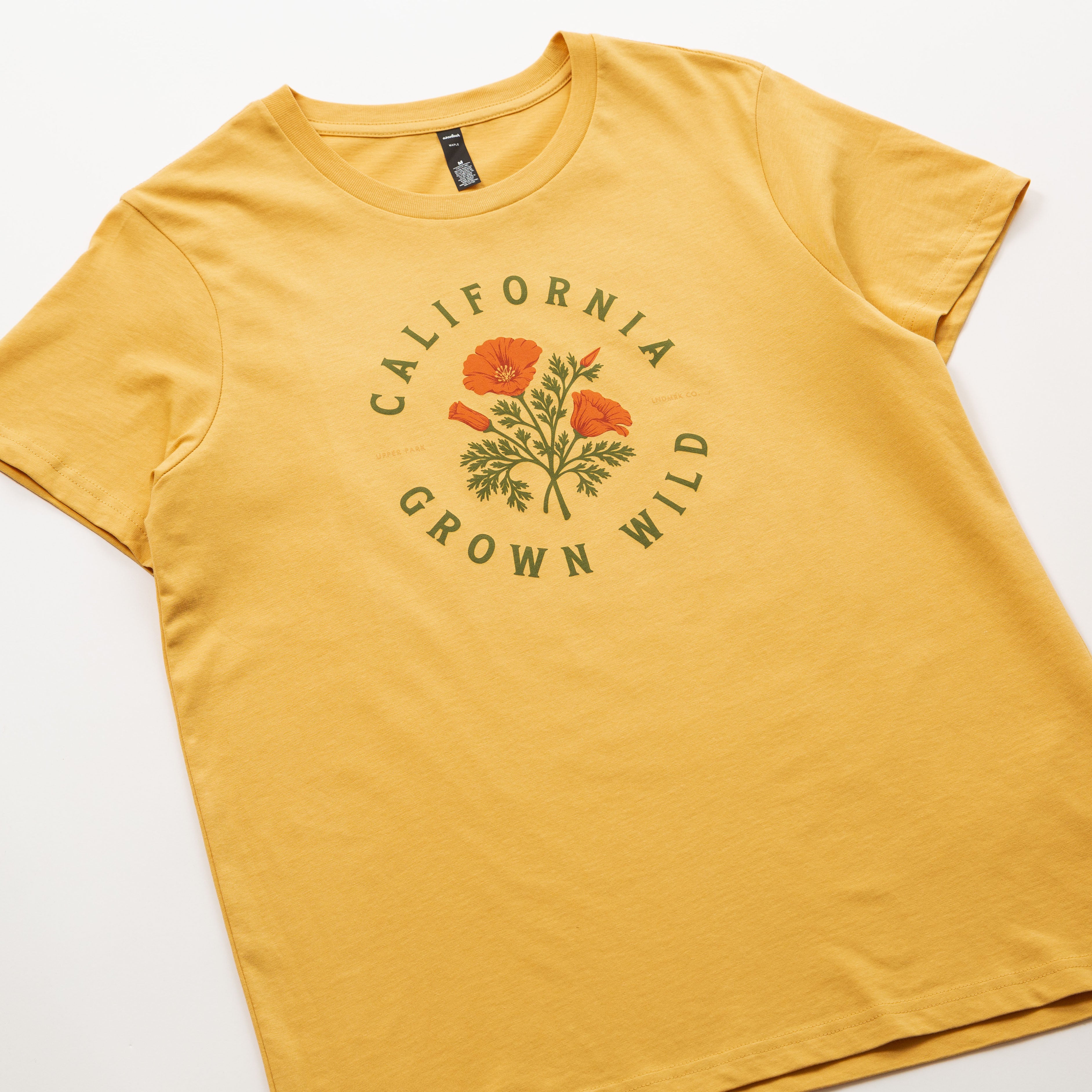 Yellow t-shirt with 'California Grown Wild' graphic on a white background