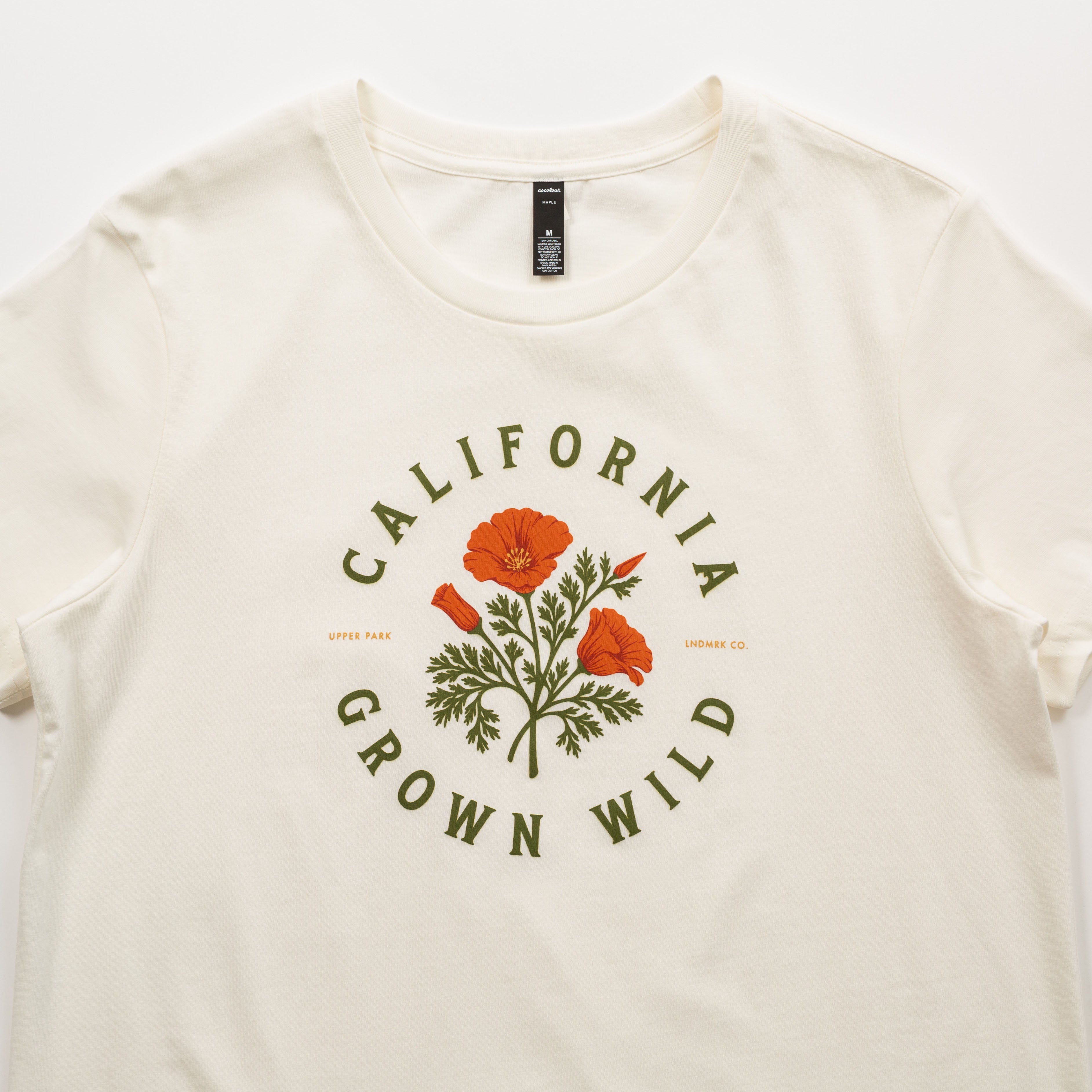 White t-shirt with 'California Grown Wild' design featuring poppies on a white background