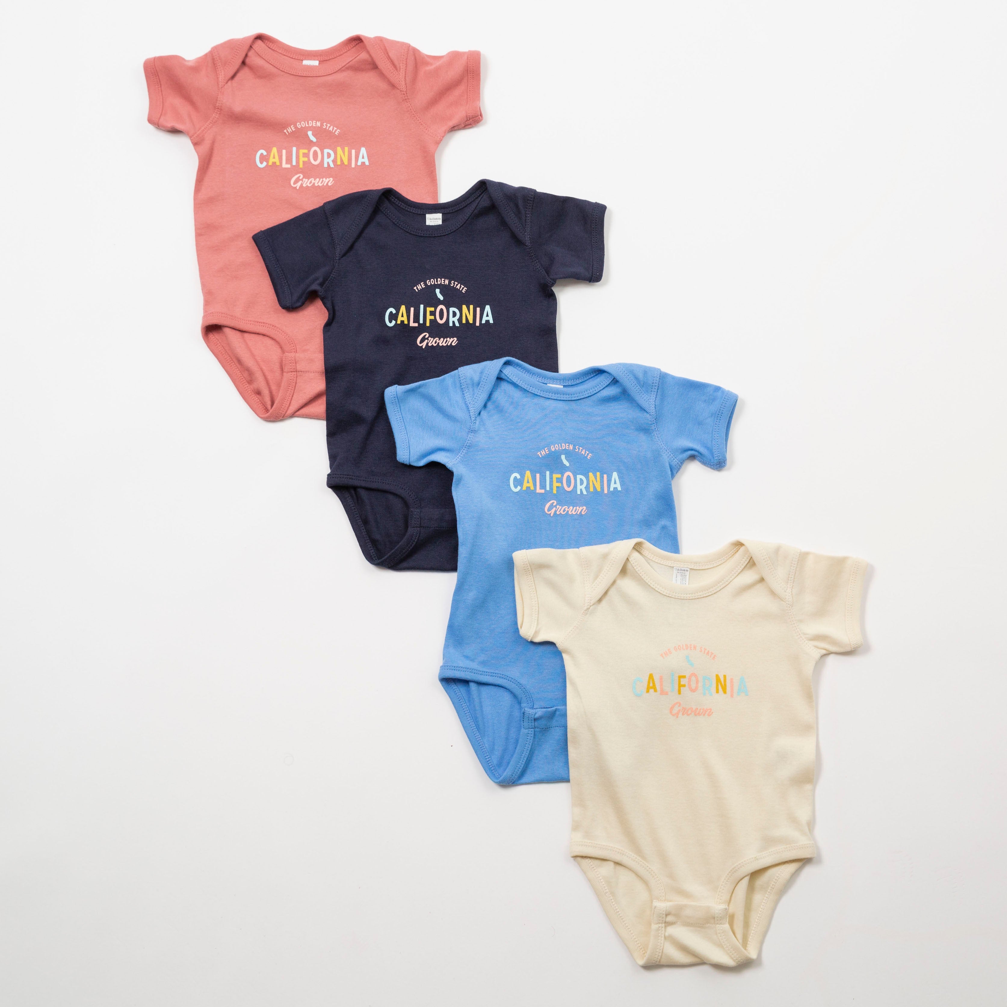 Four baby bodysuits in different colors with 'California Gurls' text on a white background - Upper Park Baby Onesie California Collection