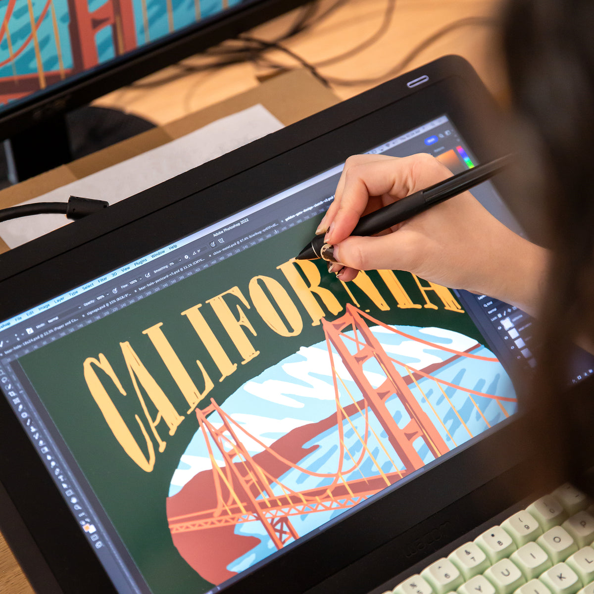 women drawing on a wacom tablet drawing the Golden Gate Bridge in San Francisco California new graphic Golden State Embroidery at Upper Park Clothing in Chico,CA