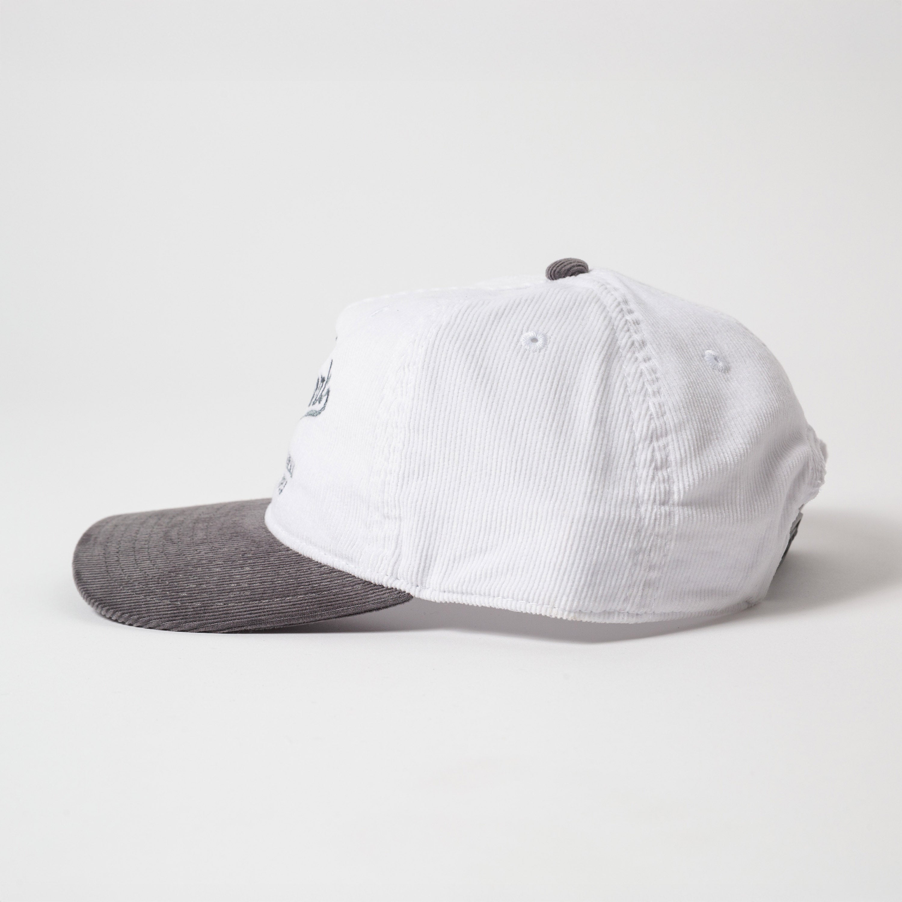 Menlo Embroidered Corduroy Hat - Side profile of vintage style two-tone cap with white front and gray back on a light gray background
