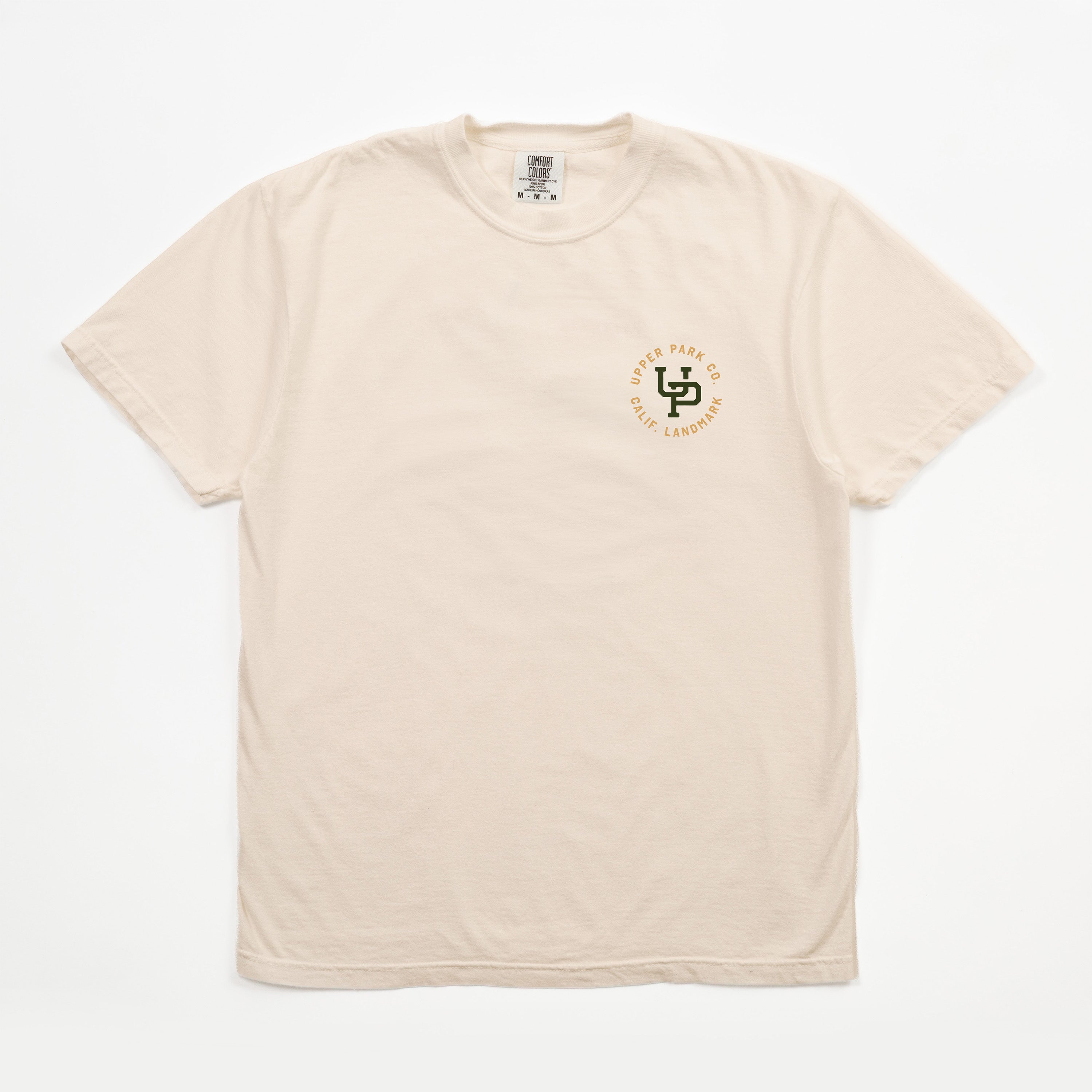 A light beige crewneck t-shirt with a small circular chest graphic on the left side. The graphic features a green and gold logo with the text 'SD 2025 WESTERN CALIFORNIA CHAMPIONS'.