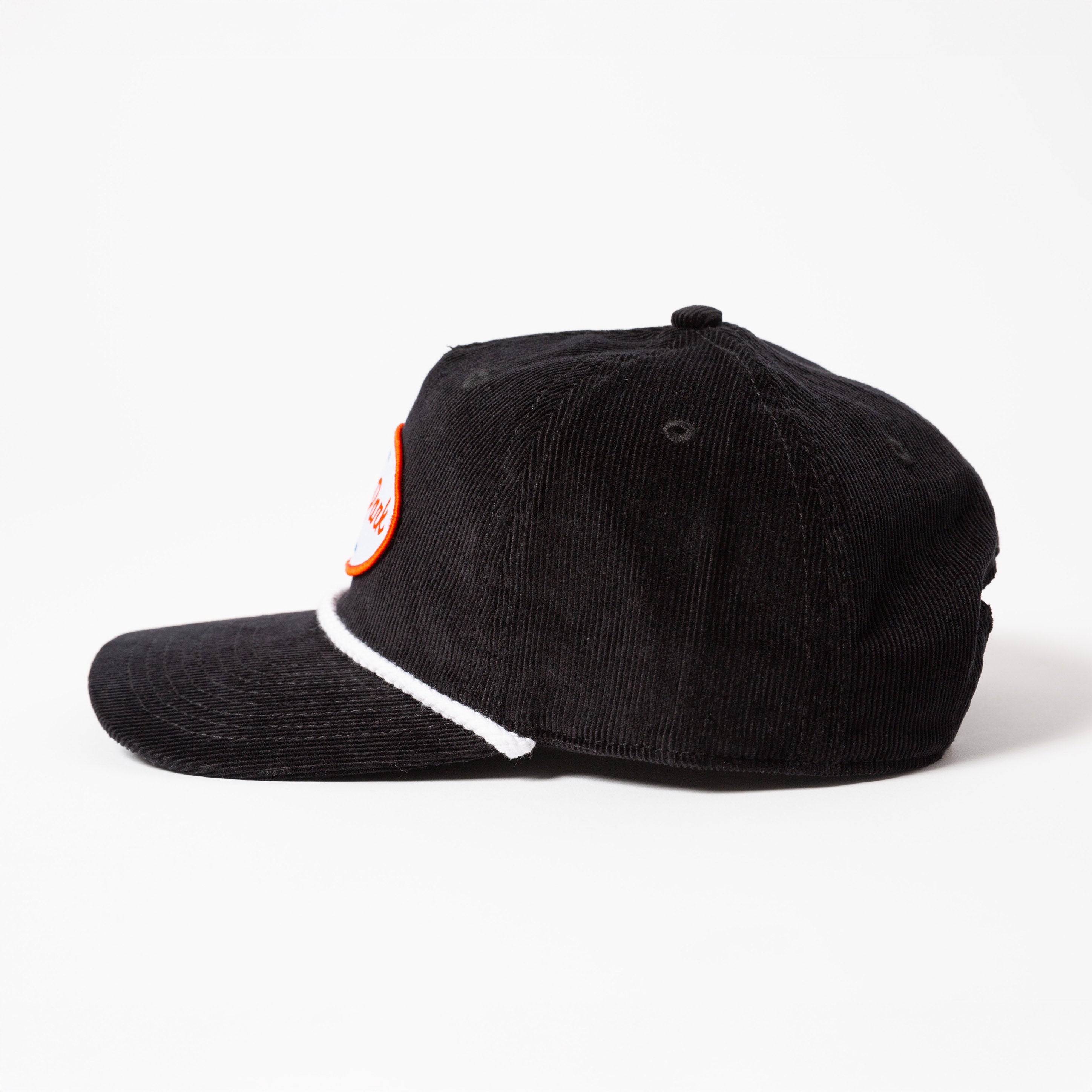 Black cap with a white brim and orange tag on a white background - Values Corduroy Rope Hat