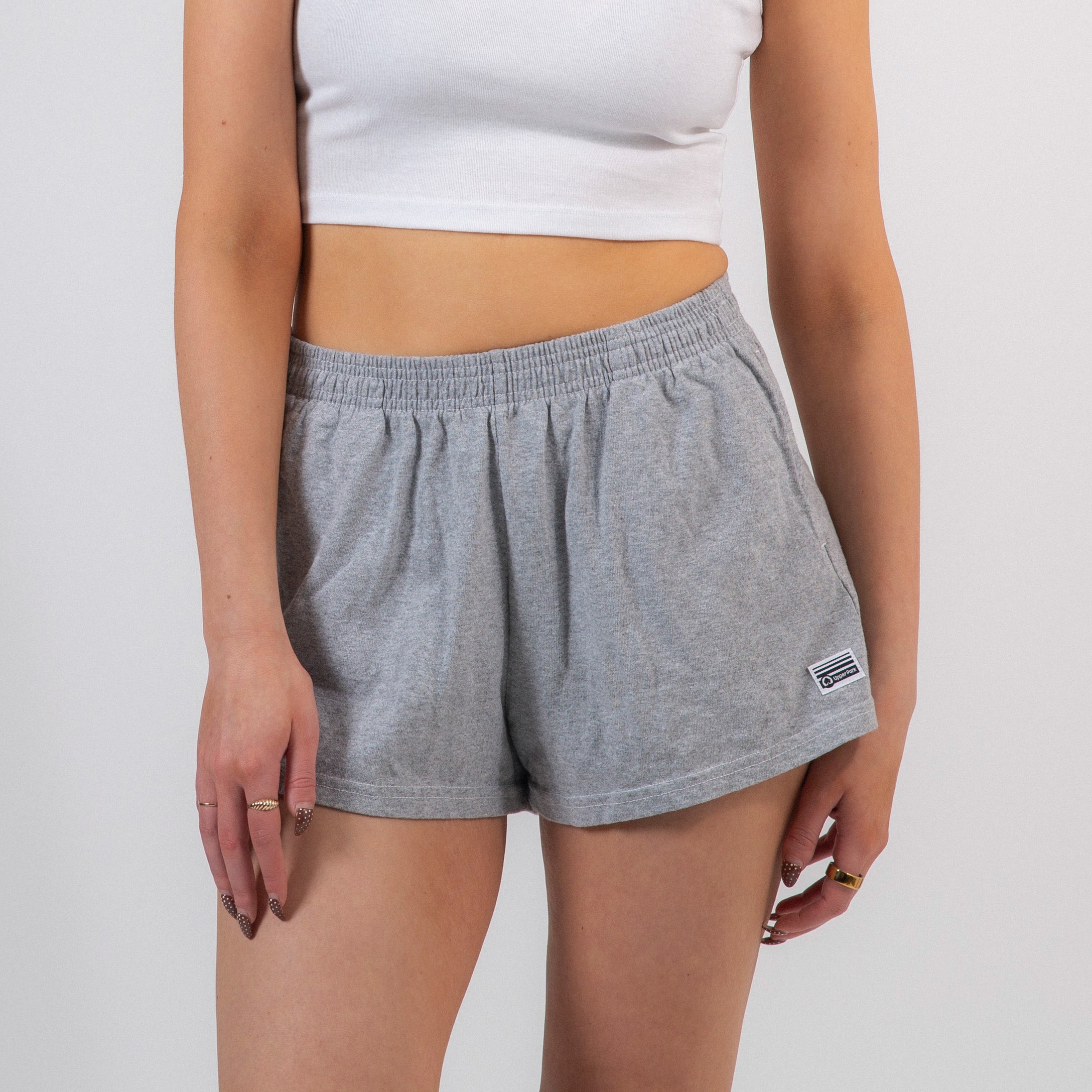 Person wearing gray shorts with a white background - Cotton Gym Shorts