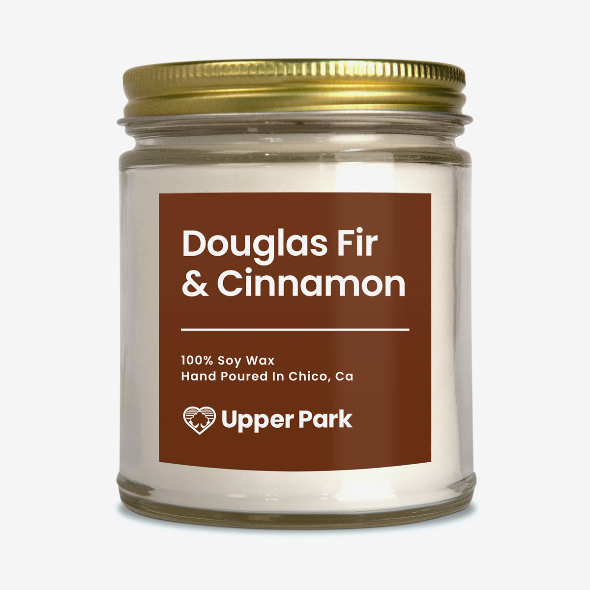Douglas fir and cinnamon candle on a white background
