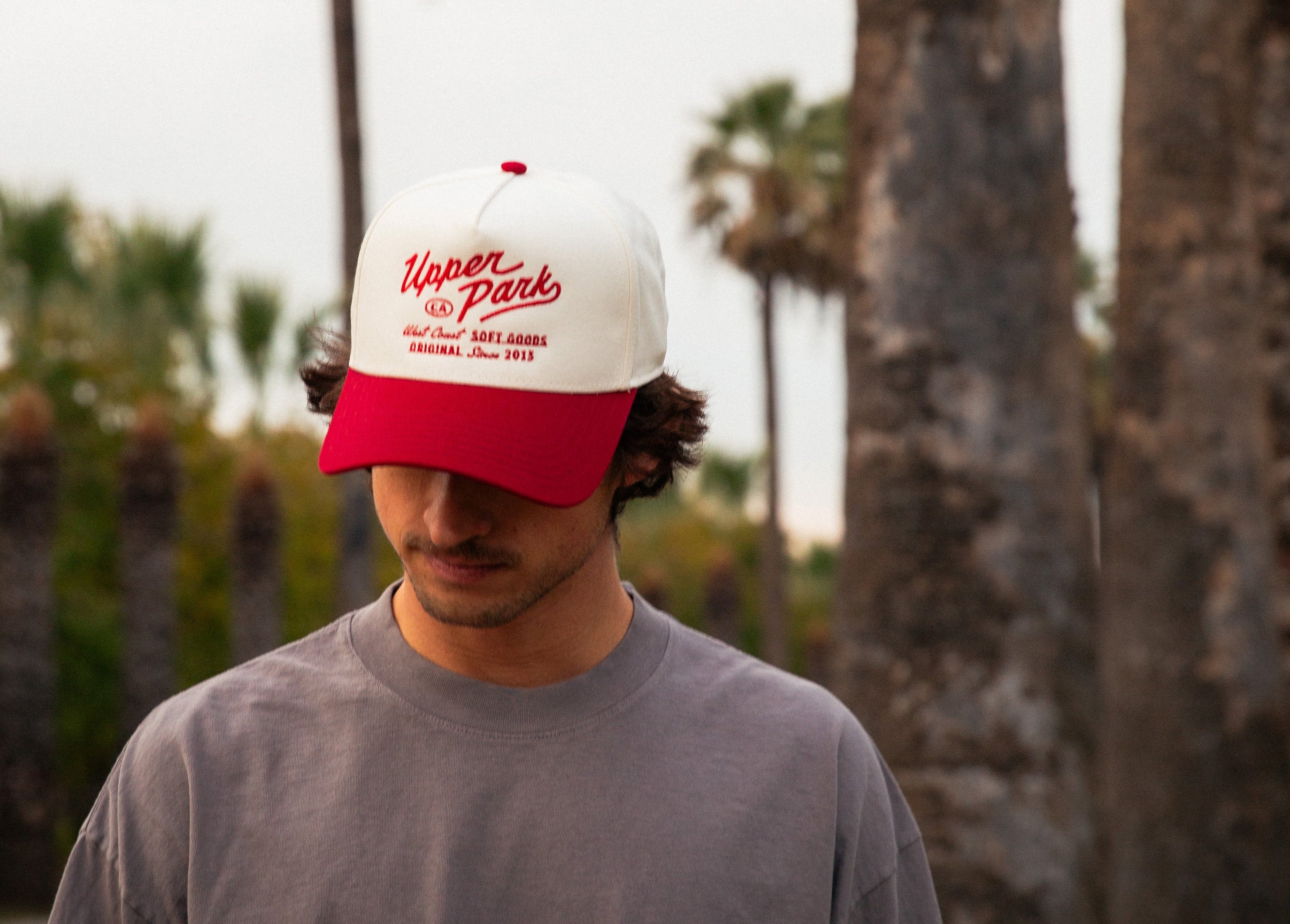 Upper Park Hat Two Tone Vintage Style - model wearing hat in front of palm trees