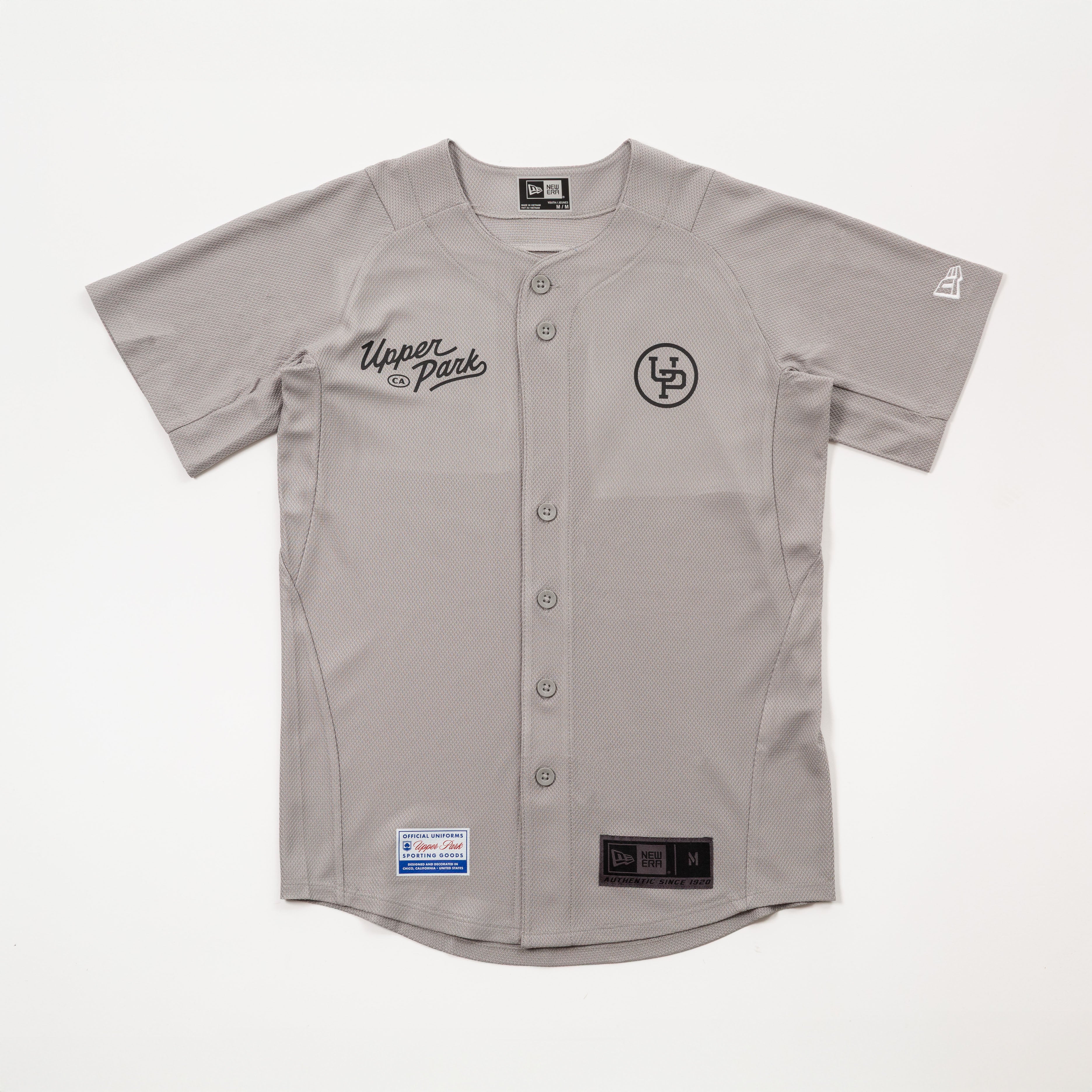 Gray baseball jersey with brand logos on a white background - 530 Upper Park New Era Jersey