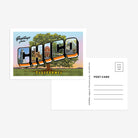 A postcard featuring a colorful illustration of a tree with 'GREETINGS FROM CHICO' text above it, set against a background of the Hooker Oak, with a postage stamp below the image.