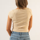 Person wearing a beige t-shirt and blue jeans on a plain background - Women's Basics - Baby Rib Square Neck Shirt