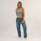Woman wearing a gray tank top and blue jeans on a white background - Women's Basics - Baby Rib Tank Top