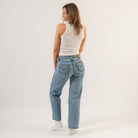Woman wearing blue jeans and a white tank top on a plain background - Women's Basics - Baby Rib Tank Top