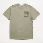 A light sage green crewneck t-shirt with a small graphic print on the left chest featuring a stylized scene and the text 'UPPER PARK california landmark co.' on a white background