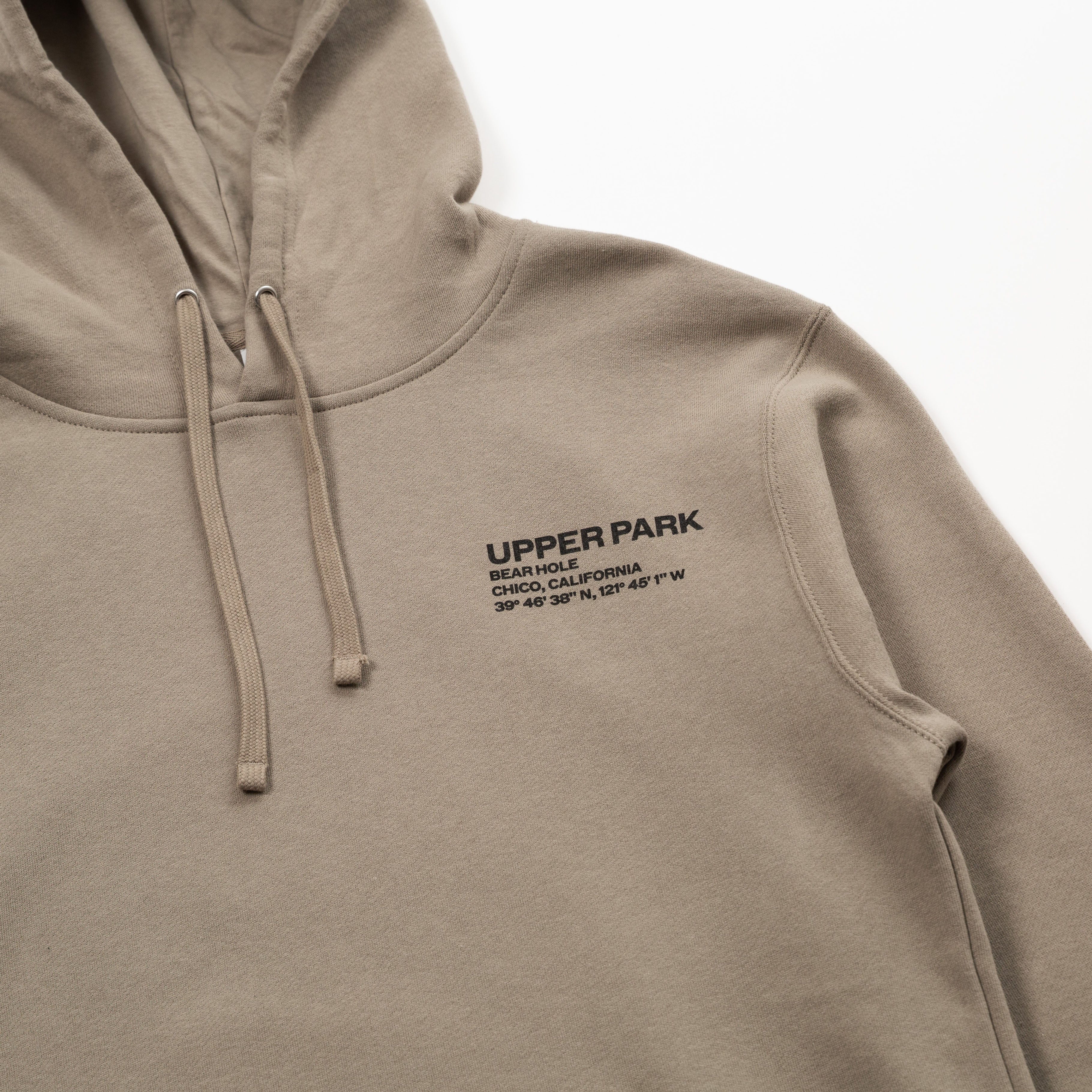 Beige hoodie with 'Upper Park' text on a white background
