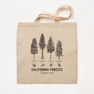 Beige tote bag with black tree illustrations and text on a white background