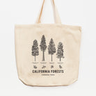 A beige cotton tote bag with illustrations of trees and the text 'California Forests' printed on the front.