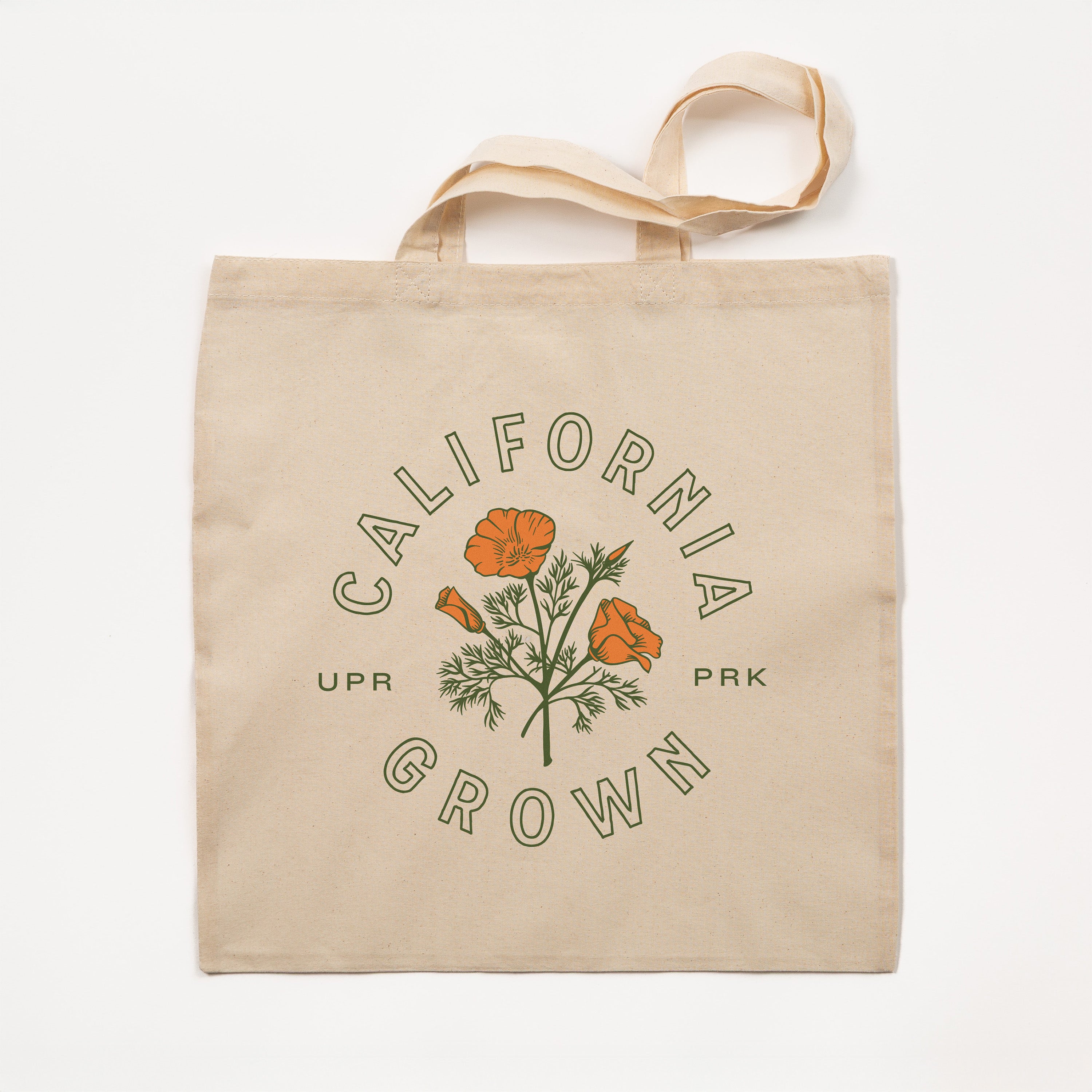 Beige tote bag with 'California Grown' and floral design on a white background