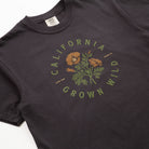 Black t-shirt with 'California Grown Wild' graphic on a white background