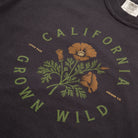 Black t-shirt with 'California Grown Wild' design featuring poppies and green leaves.