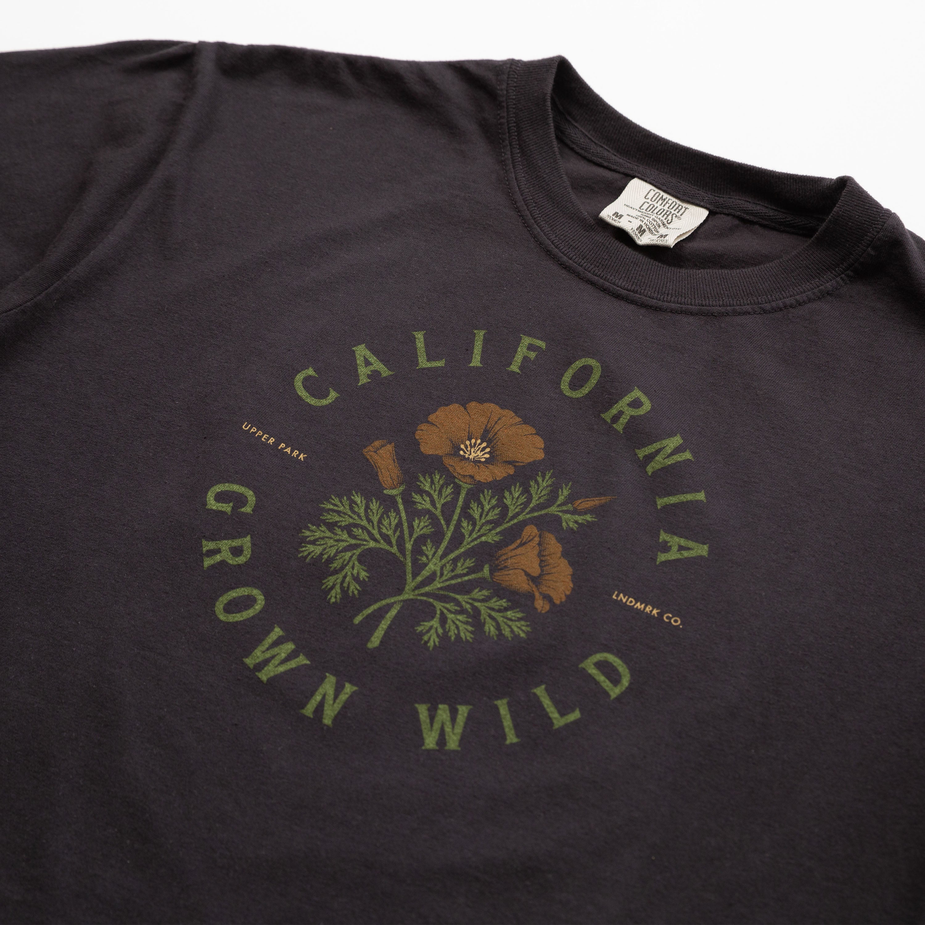 Black t-shirt with 'California Grown Wild' graphic on a white background