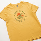 Yellow t-shirt with 'California Grown Wild' graphic on a white background