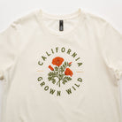 White t-shirt with 'California Grown Wild' design featuring poppies on a white background