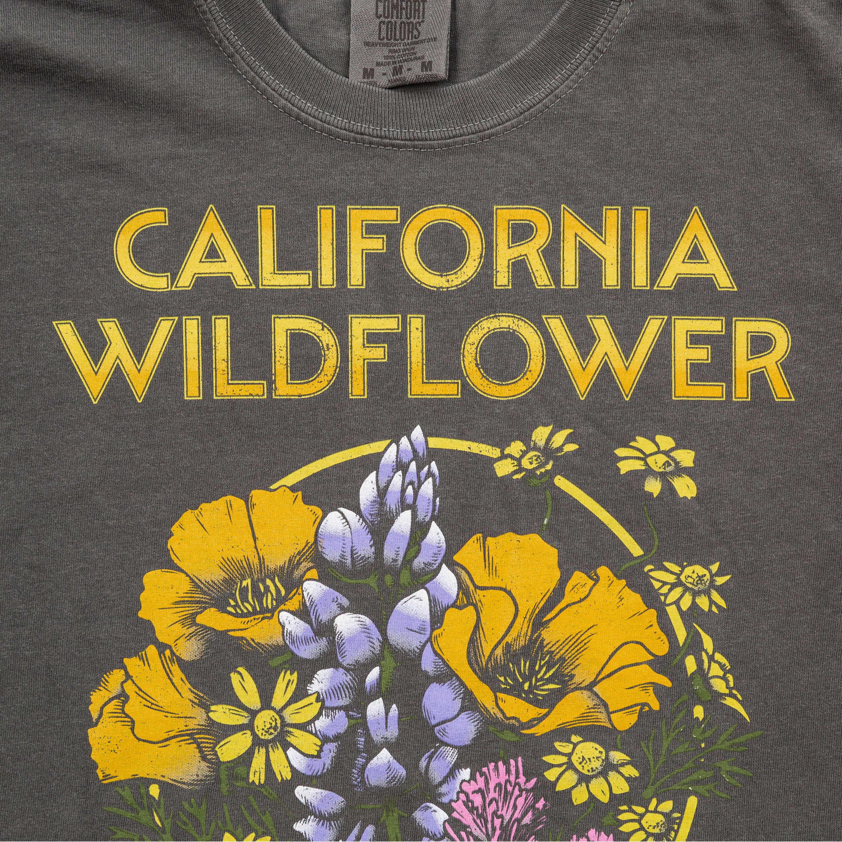 Dark gray t-shirt with 'California Wildflower' text and floral design in yellow and purple - Upper Park California Collection