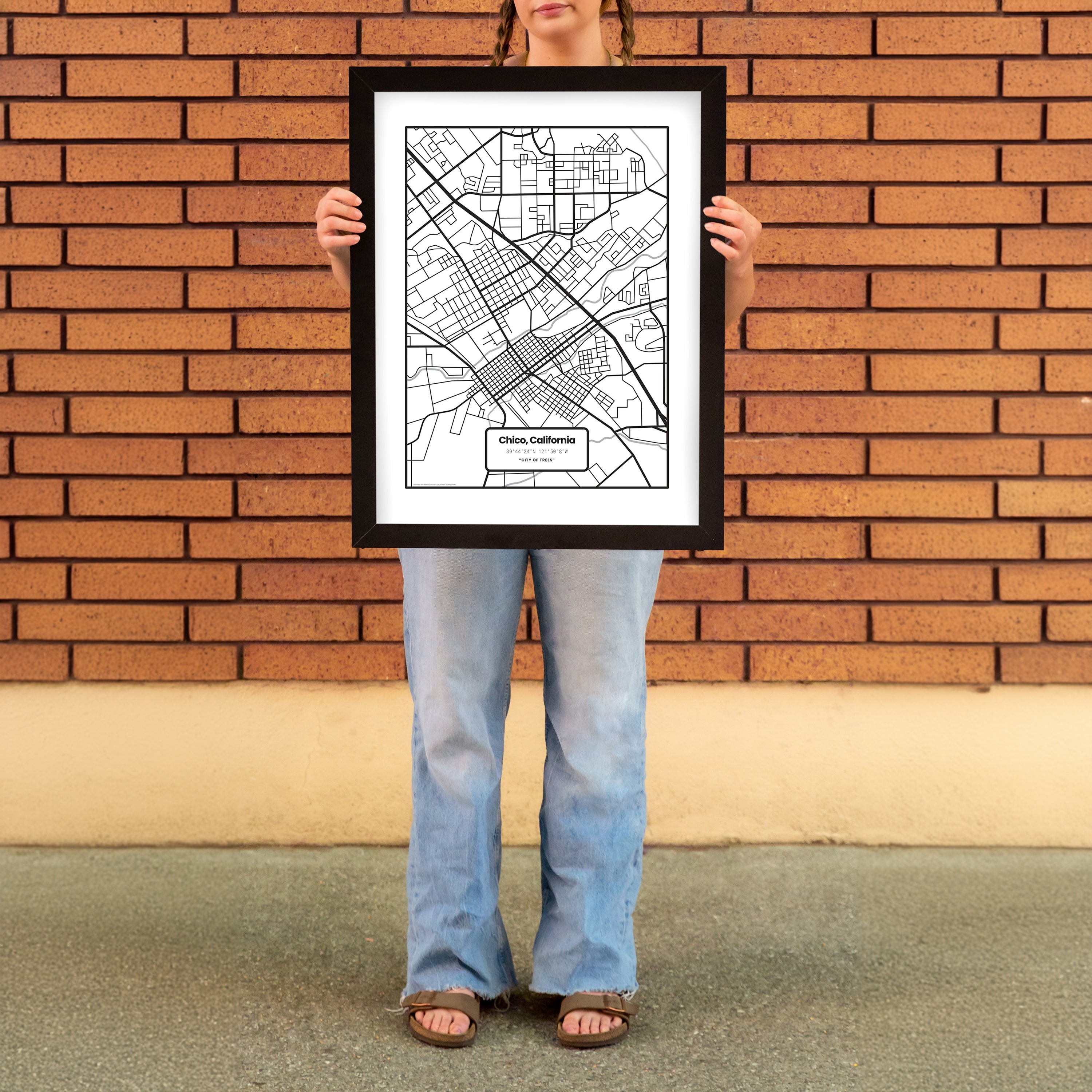 Woman holding a Chico Map Minimal Poster Print from Upper Park Clothing in Chico, Ca