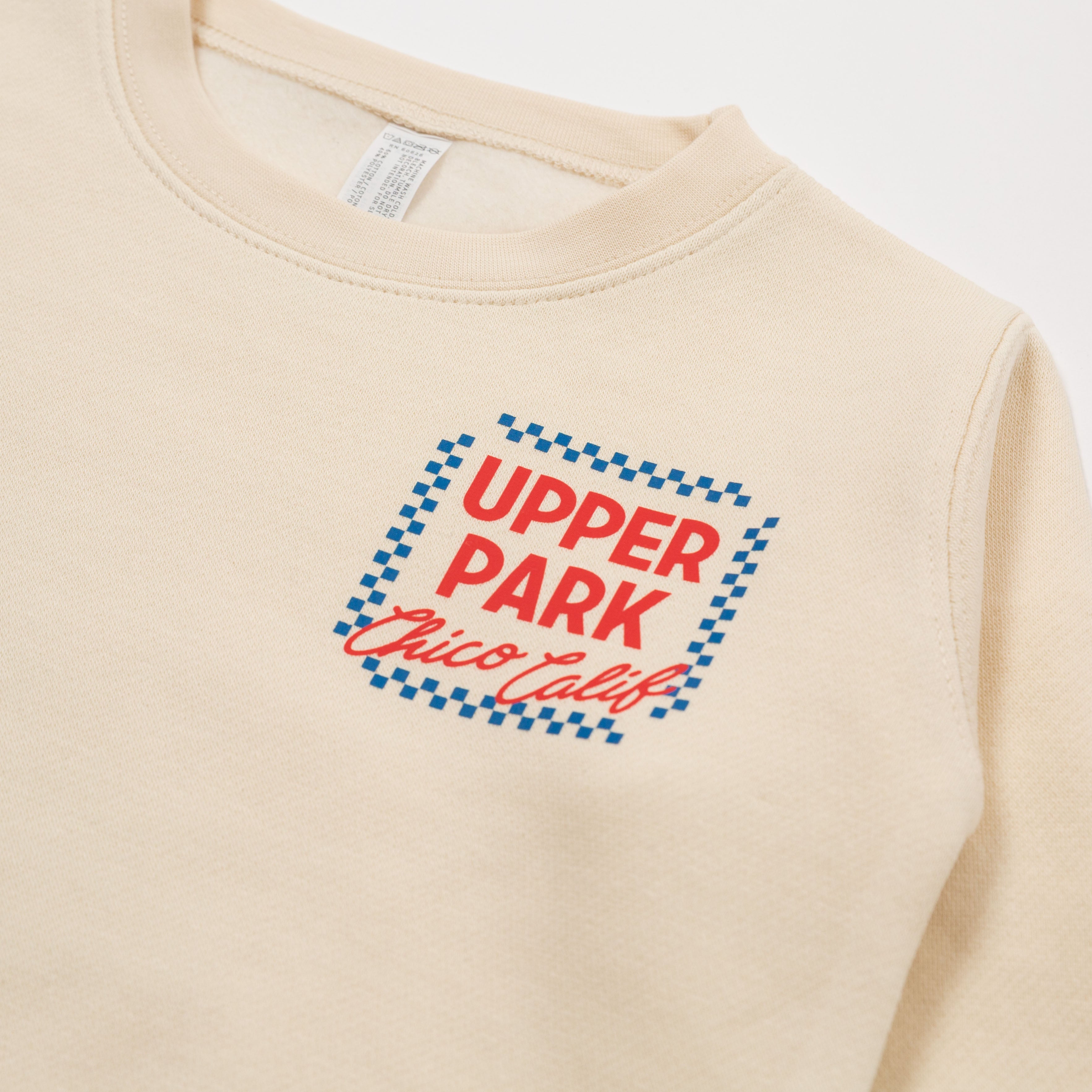 Beige sweatshirt with 'Upper Park Chico Calif' text on a white background - Upper Park Clothing Toddler Crewneck SweatshirtSweatshirt