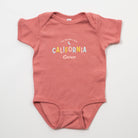 Pink baby onesie with 'California Grown' text on a white background - Upper Park Baby Onesie California Collection