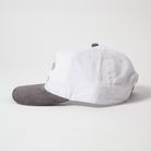 Menlo Embroidered Corduroy Hat - Side profile of vintage style two-tone cap with white front and gray back on a light gray background