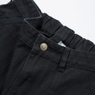Men's Shorts Heavy Duck Canvas - Upper Park Clothing - Close-up of black pants with a button on a white background