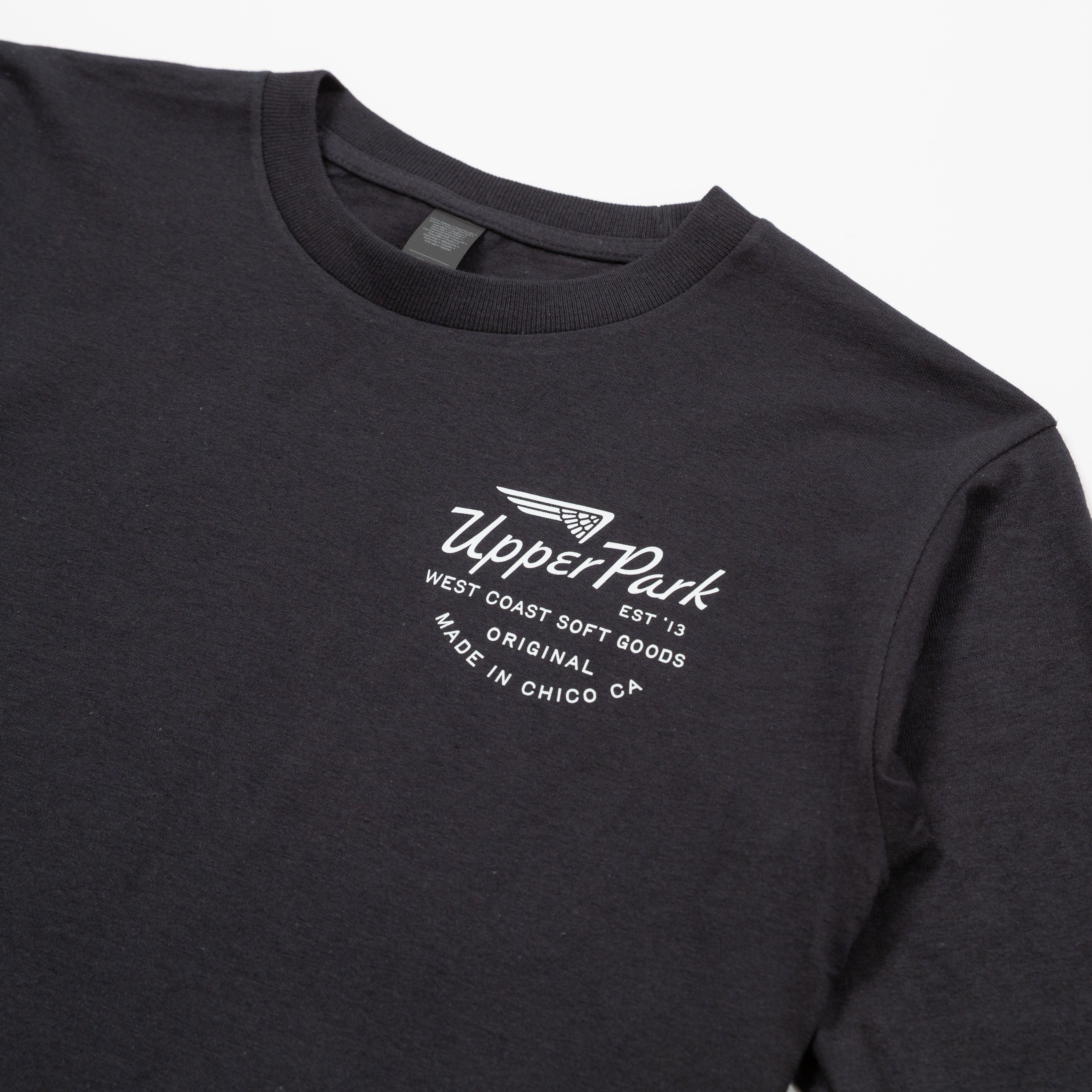 Black shirt detail with a white Upper Park logo and text on a light gray background