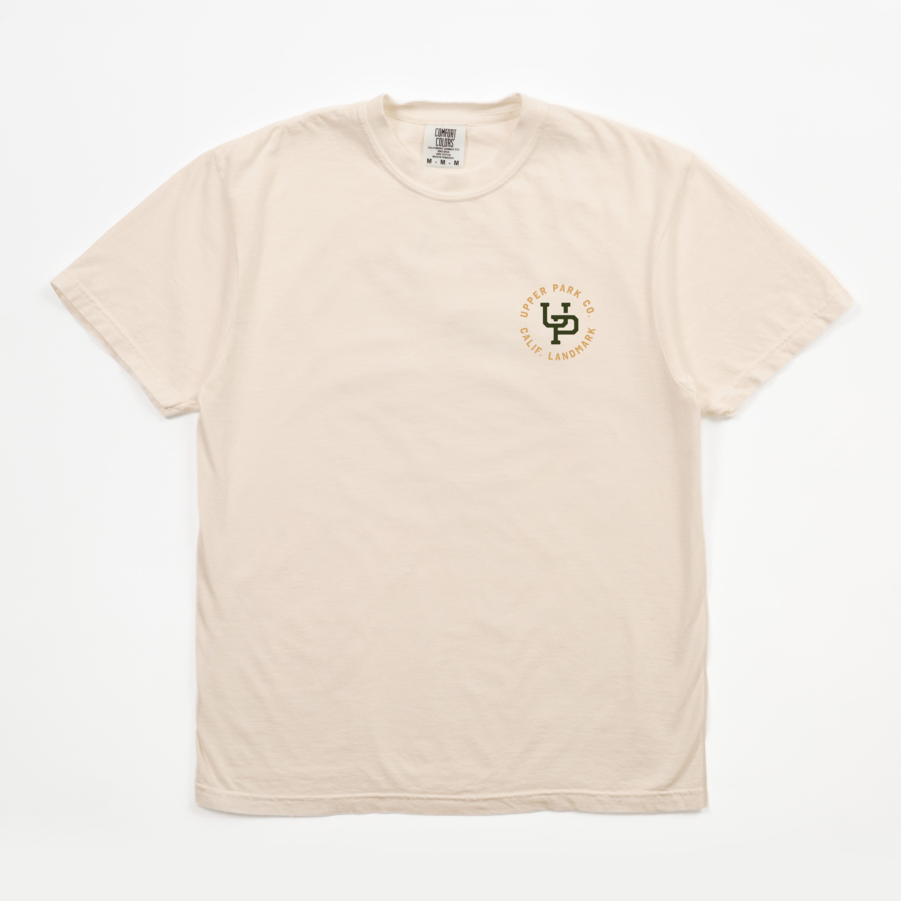 A light beige crewneck t-shirt with a small circular chest graphic on the left side. The graphic features a green and gold logo with the text 'SD 2025 WESTERN CALIFORNIA CHAMPIONS'.