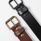 A brown and black leather belt with metal belt buckles on a white background - UPR PRK etched into the leather - Upper Park Basic Leather Belt