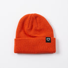 Orange beanie with a black label on a white background